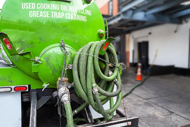 worker pumping grease trap at commercial kitchen in Bryn Mawr